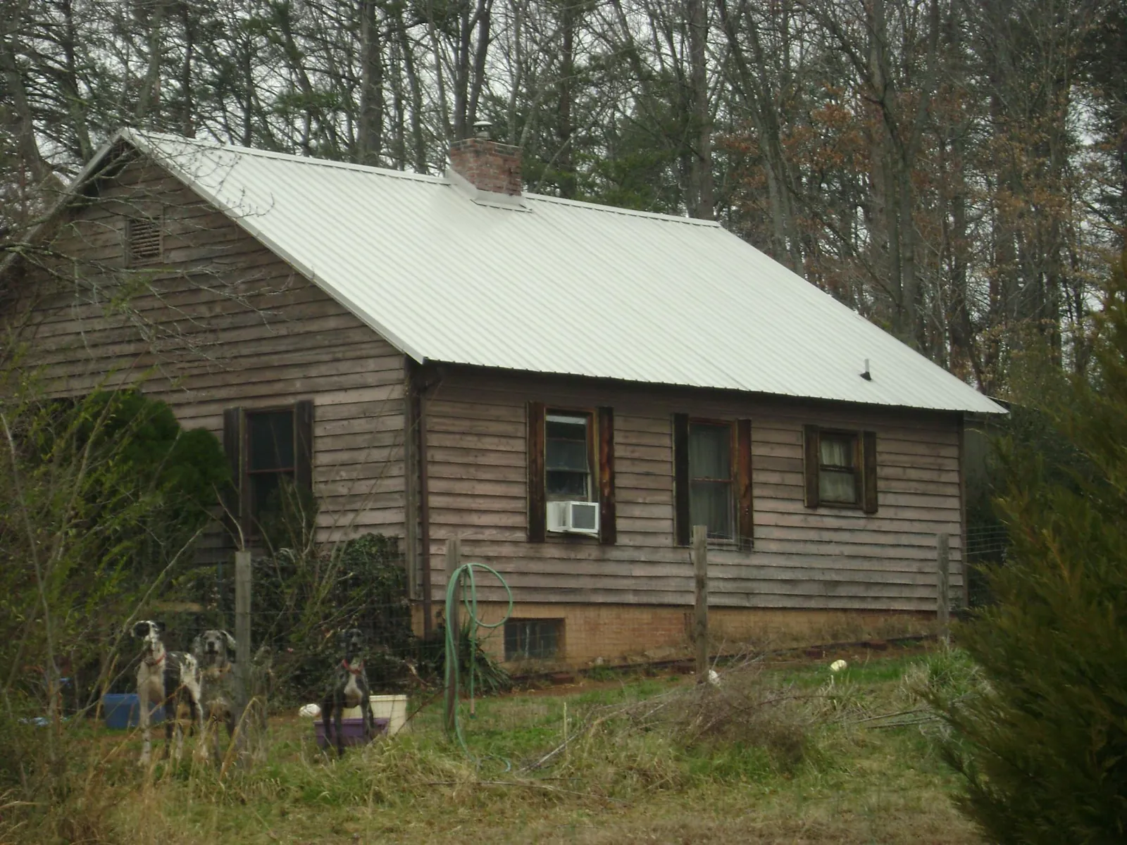 White metal roof on an old wood sided farmhouse, from a Metal Roof Installation job in Bath Springs